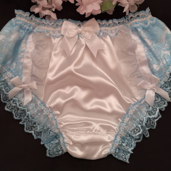May include: White satin underwear with blue lace trim and white satin bows. The underwear has a ruffled edge.