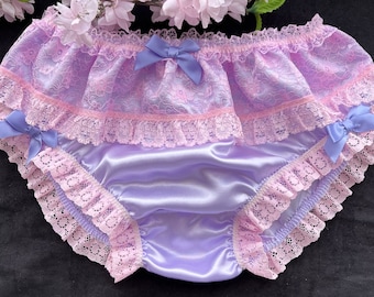 May include: Purple satin underwear with pink lace trim and bows. The underwear has a ruffled design and is made of soft, delicate fabric.