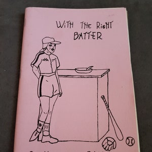 May include: Pink zine cover with black line art. The illustration features a person in a baseball uniform standing next to a table with a frying pan. Text reads "With the Right Batter" and "Cooking is a Ball."