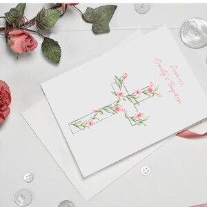 May include: A white card with a pink watercolor cross decorated with pink flowers and green leaves. The text "Jane's Baptism" and "Emily's Baptism" is printed in pink on the card.