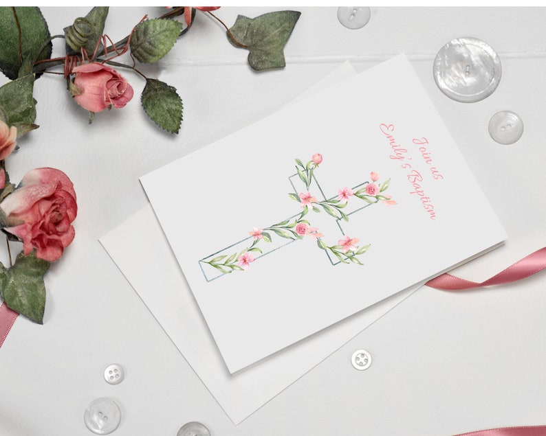 May include: A white card with a pink watercolor cross decorated with pink flowers and green leaves. The text "Jane's Baptism" and "Emily's Baptism" is printed in pink on the card.