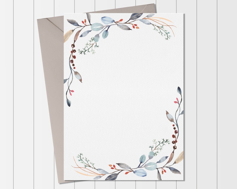May include: A white card with a watercolor border of blue and green leaves and red berries. The border is on the top and right sides of the card. The card is on a white wood background.