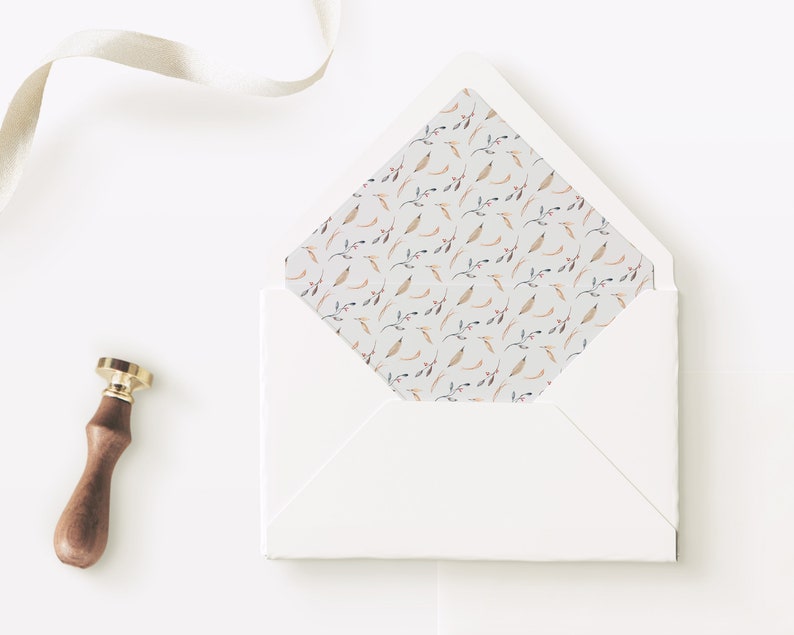 May include: A white envelope with a flap. The inside of the flap is lined with a pattern of small, light brown and pink floral sprigs on a white background. A gold and brown wax seal is next to the envelope.