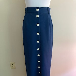 May include: A navy blue skirt with a button-up front and a high waist.