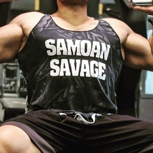 May include: A black tank top with a white camouflage pattern and the text "Samoan Savage" printed in white.