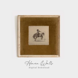 May include: A framed print featuring a sepia-toned illustration of a cowboy riding a bucking horse. The artwork is set against a gold-colored background within a gold-toned frame. The text "Haven Walls Digital Download" is at the bottom.