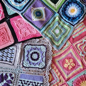 May include: A multi-colored crochet blanket composed of various square motifs featuring intricate textures, floral patterns, and geometric designs. The piece displays a vibrant palette including shades of pink, purple, blue, green, and yellow, joined together with black and light gray yarn borders.