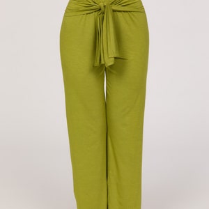May include: Lime green wide-leg trousers with a tie-waist feature. The trousers are made from a soft, flowing material. The image shows the trousers against a plain white backdrop.