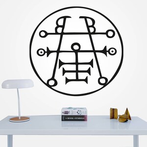 May include: A black and white illustration of a symbol inside a circle. The symbol is a geometric design with lines and circles. The illustration is on a white background.