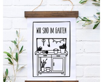 May include: Black and white illustration of a gardening shed with the text "Wir sind im Garten" (We are in the garden) on a white background.