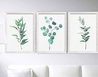 May include: Set of three framed watercolor prints featuring green botanical illustrations. Each print depicts a different arrangement of leaves and branches.