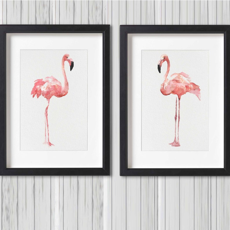 May include: Two framed watercolor paintings of pink flamingos on a white background. The frames are black and have a white mat.