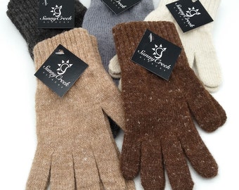 May include: Five pairs of alpaca gloves in different colors, including brown, beige, gray, and white. Each pair has a black tag with the words "Sunny Creek Alpaca" printed on it.