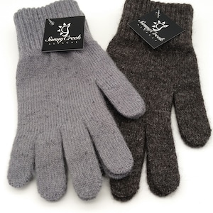 May include: Two pairs of alpaca knit gloves, one gray and one brown. The gloves are made by Sunny Creek Alpacas.
