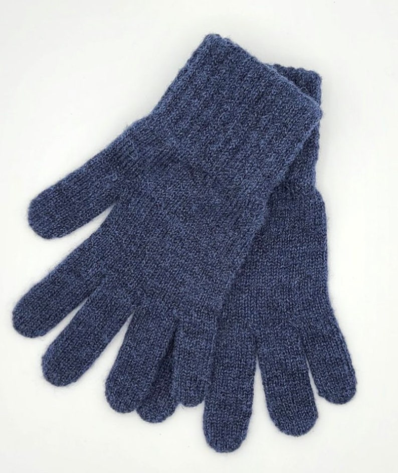 May include: A pair of blue knitted gloves with a textured pattern. The gloves are made of a soft, warm material and are perfect for keeping your hands warm in cold weather.