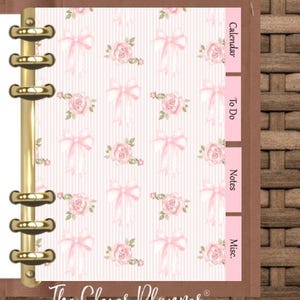 May include: A planner insert with a pink and white floral pattern featuring bows and roses. The planner has gold rings and pink tabs labeled "Calendar", "To Do", "Notes", and "Misc." The Clever Planner logo is at the bottom.