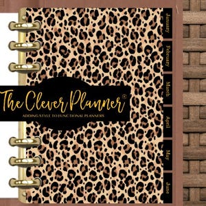 May include: A disc-bound planner featuring a leopard print cover and gold-toned metal discs. A black horizontal label displays the text The Clever Planner ADDING STYLE TO FUNCTIONAL PLANNERS. Black monthly tabs for January through June are visible.
