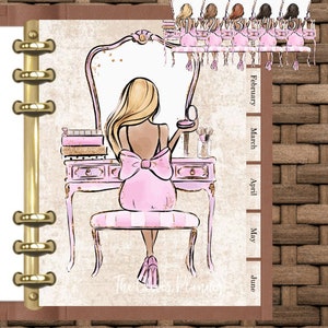 May include: A digital planner cover featuring a woman sitting at a vanity with a mirror, a pink dress, and a large pink bow. The cover has a brown wicker background and a gold ring binder.