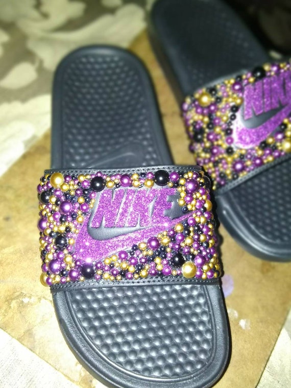 purple and gold nike slides