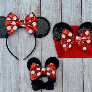 May include: Three black and red Minnie Mouse inspired headbands with red and white polka dot bows. The headband on the left is a headband with ears, the middle headband is a knotted headband, and the headband on the right is a headband with ears.
