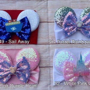 May include: Four different headband styles with various colors and designs. The headbands are made of soft fabric and feature a bow or ears. The designs include a blue and white ship, a rainbow with a pearl, a pink and purple bow with a pearl, and a white and pink castle.