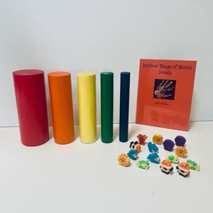 May include: A set of rainbow-colored dowels for range of motion exercises, with a booklet titled "Rainbow Range of Motion Dowels" and colorful foam animal figurines.