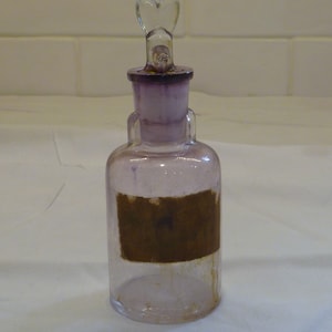 antique glass jar with dog head stopper