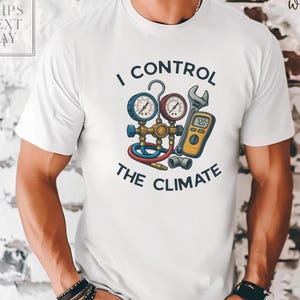 May include: White t-shirt featuring the text "I CONTROL THE CLIMATE" and an illustration of HVAC tools. The graphic includes gauges, a wrench, and a digital multimeter. The shirt has a crew neck.