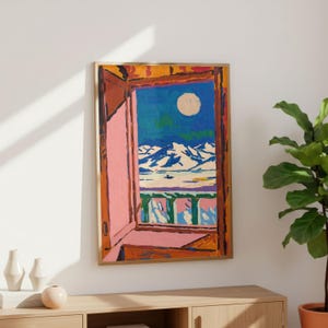 May include: A framed painting depicting an open window looking out onto a snowy mountain landscape under a full moon. The window frame is painted in shades of orange and pink, while the exterior scene features blue skies, white peaks, and a balcony.
