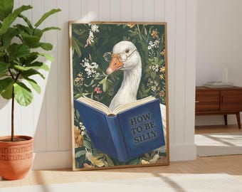 May include: A framed art print featuring a white goose wearing glasses and reading a blue book with the words "HOW TO BE SILLY." The background is a dark green with floral elements.
