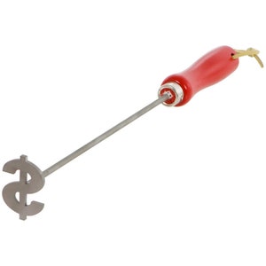 May include: A red-handled metal branding iron with a dollar sign design. The branding iron is used to mark food with a dollar sign.