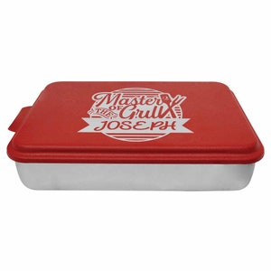 May include: Red baking pan with a white lid. The lid has a white design that says "Master of the Grill" with the name "Joseph" underneath.
