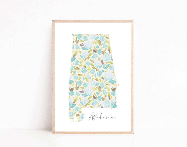 May include: A framed print of the state of Alabama with a floral pattern in shades of blue, green, and brown. The print is on a white background and the state name is written in cursive at the bottom.