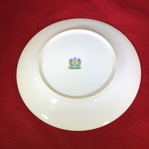 May include: White ceramic plate with a green and blue logo that reads "Imperial China, Made in Japan".