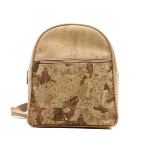 May include: A tan cork backpack with a zippered pocket and a patterned cork design.