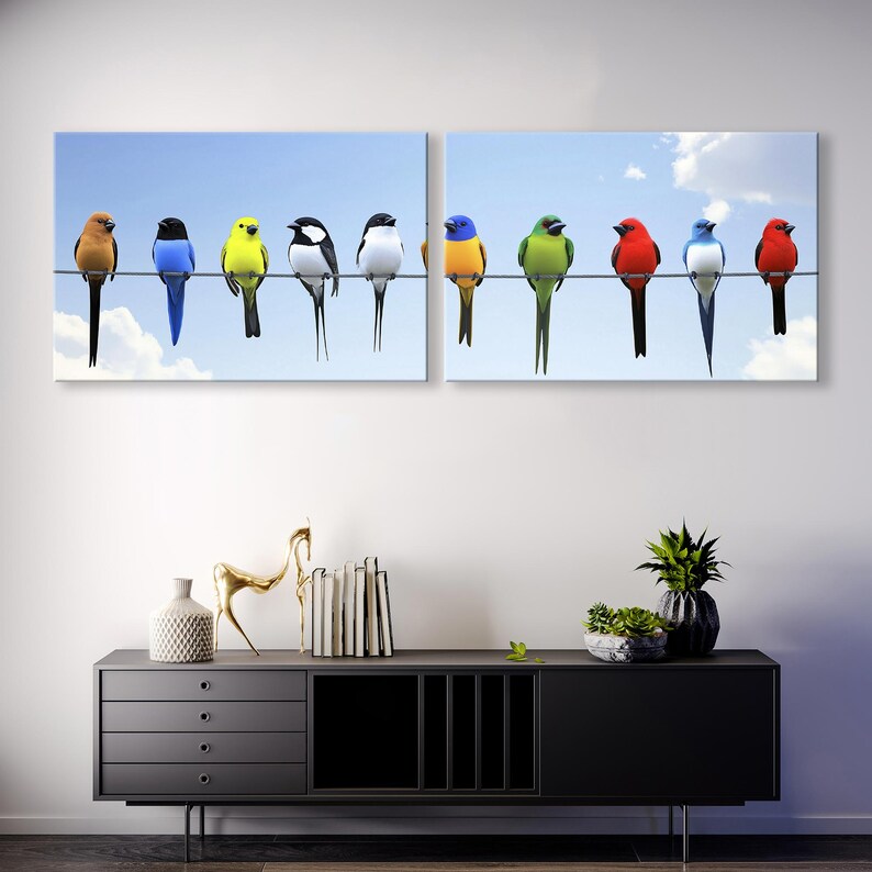 May include: Diptych wall art featuring two panels showcasing a vibrant row of colorful birds perched on a wire against a light blue sky. The birds are depicted in various colors, including red, yellow, green, blue, and black. The artwork is a nature-themed piece suitable for home or office decor, adding a touch of color and life to any space. The birds are realistically rendered, and the overall style is clean and modern.