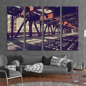 May include: A tri-panel canvas print of a city street scene with a bridge overhead. The bridge is made of metal and has a grid pattern. The buildings in the background are tall and modern. The image is in a vintage style with a faded color palette.