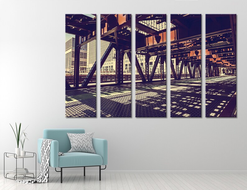 May include: A panoramic view of a city bridge with a vintage filter applied. The bridge is made of steel and has a grid-like pattern on the walkway. The city skyline is visible in the background.