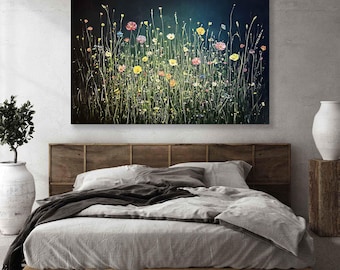 May include: A canvas painting shows a vibrant field of wildflowers in shades of yellow, pink, and orange against a dark backdrop. The artwork hangs above a bed with grey linens and a wooden headboard. The painting's dimensions are not visible.