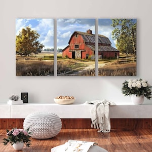 May include: A three-panel canvas art piece depicting a rural landscape with a red barn as the focal point. The barn is surrounded by fields, trees, and a dirt path. The sky is blue with fluffy clouds. The artwork is displayed above a white shelf.
