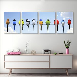 May include: A vibrant multi-panel canvas print featuring a row of colorful birds perched on a wire against a light blue sky. The birds are in various colors including red, blue, green, yellow, and black. The artwork is a nature-themed piece suitable for home decor, adding a pop of color to any room.  The birds are depicted realistically, showcasing their plumage and details. The print is divided into three panels for a modern, gallery-style display.