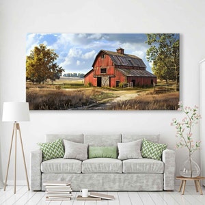May include: A large rectangular canvas print depicts a rural landscape with a red barn as the focal point. The barn has a weathered appearance, with a dark roof and visible wooden doors. The surrounding area features fields, trees, and a cloudy sky.