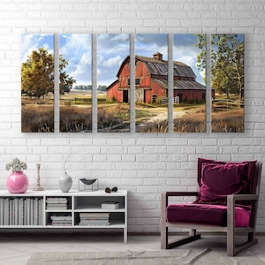 May include: A multi-panel canvas print depicting a rural landscape with a red barn under a cloudy sky. The artwork features a dirt path leading to the barn, surrounded by fields and trees. The print is displayed on a white brick wall, with a modern white cabinet and a burgundy armchair.