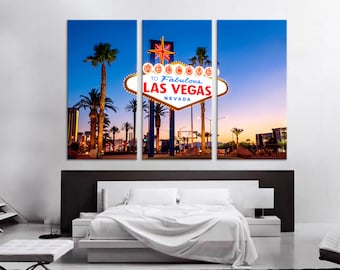 May include: A three-panel canvas print featuring a nighttime view of the iconic "Welcome to Fabulous Las Vegas, Nevada" sign with palm trees and a colorful sunset in the background.
