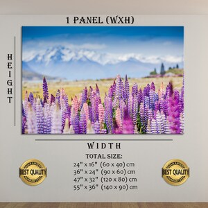 May include: A canvas print featuring a field of purple and pink lupine flowers with a snow-capped mountain range in the background. The print is available in multiple sizes, including 60 cm x 40 cm, 90 cm x 60 cm, 120 cm x 80 cm, and 140 cm x 90 cm.