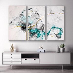 May include: Abstract art print set of three panels featuring teal and black swirls with gold accents on a white background.