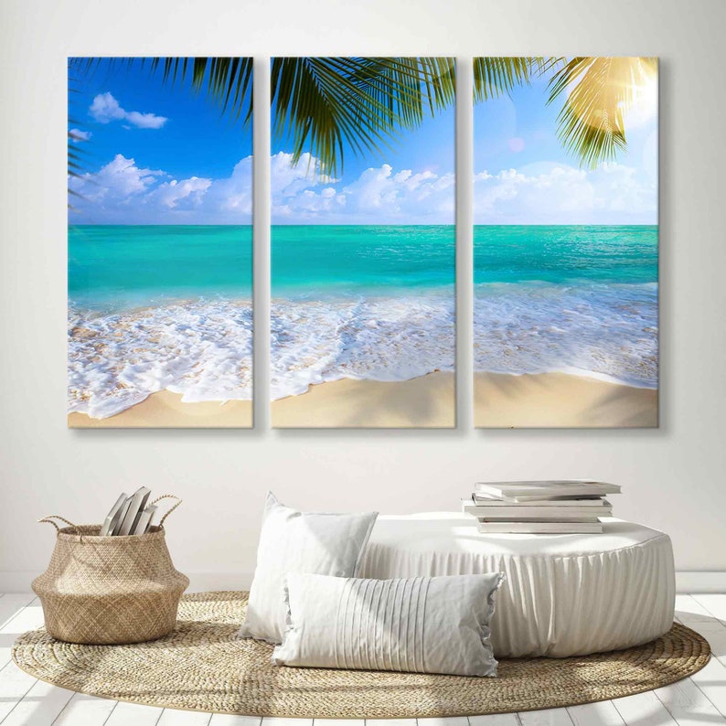 May include: A three-panel canvas print depicting a tropical beach scene with turquoise water, white sand, and palm tree leaves.