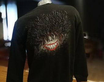 Sudadera con gráficos pintados a mano: un jersey artístico para llevar puesto