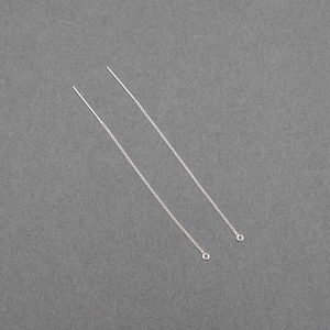 May include: Two silver threader earrings. Each earring features a thin, straight post connected to a delicate chain. The chain ends with a small, round loop. The earrings are displayed on a gray background.
