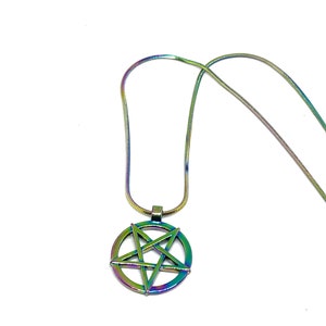 May include: A rainbow iridescent pendant necklace featuring a pentagram design. The chain is a snake chain style.